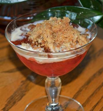 rhubarb with crisp topping in a  stemmed dessert glass